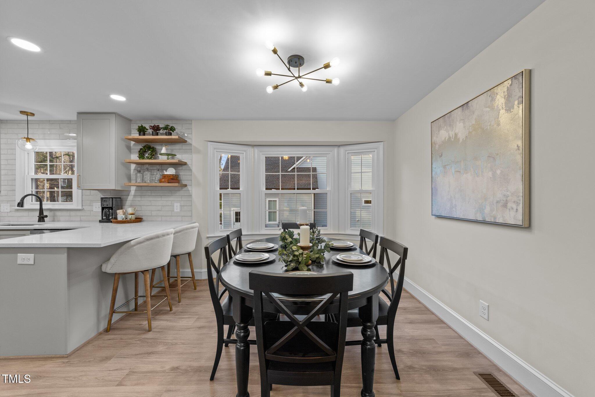 2108 Rangecrest Road Raleigh, NC 27612 - Photo 7 of 38 a view of a dining room with furniture and wooden floor