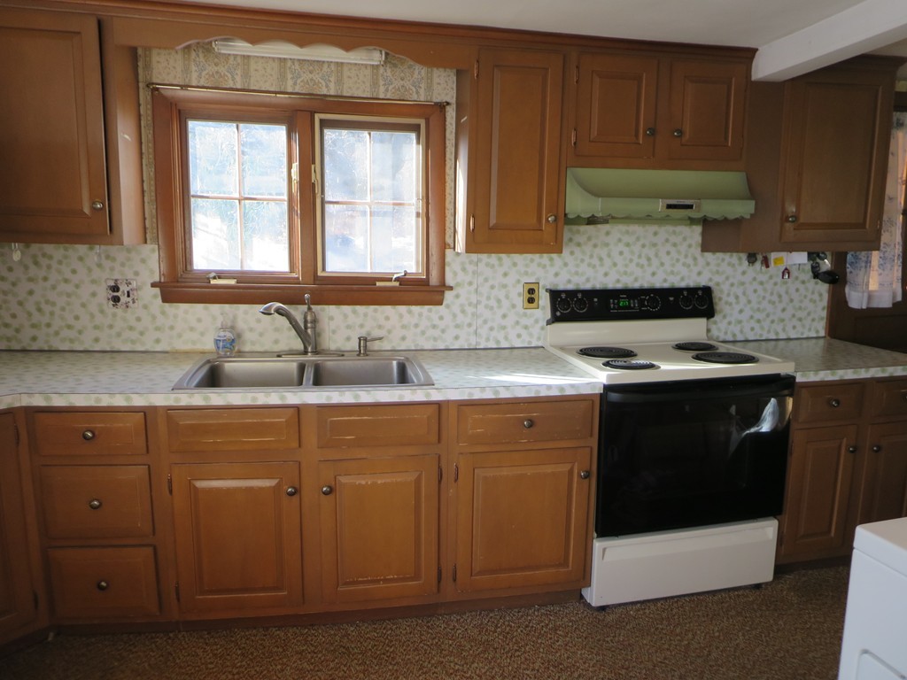 28 Craig Road Holland, MA 01521 - Photo 6 of 19 a kitchen with granite countertop a sink stove and cabinets