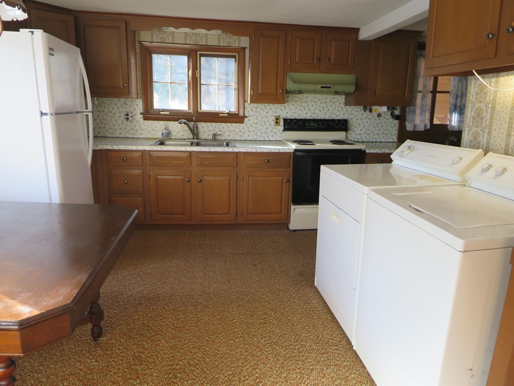 28 Craig Road Holland, MA 01521 - Photo 8 of 19 a kitchen with a sink a stove and refrigerator