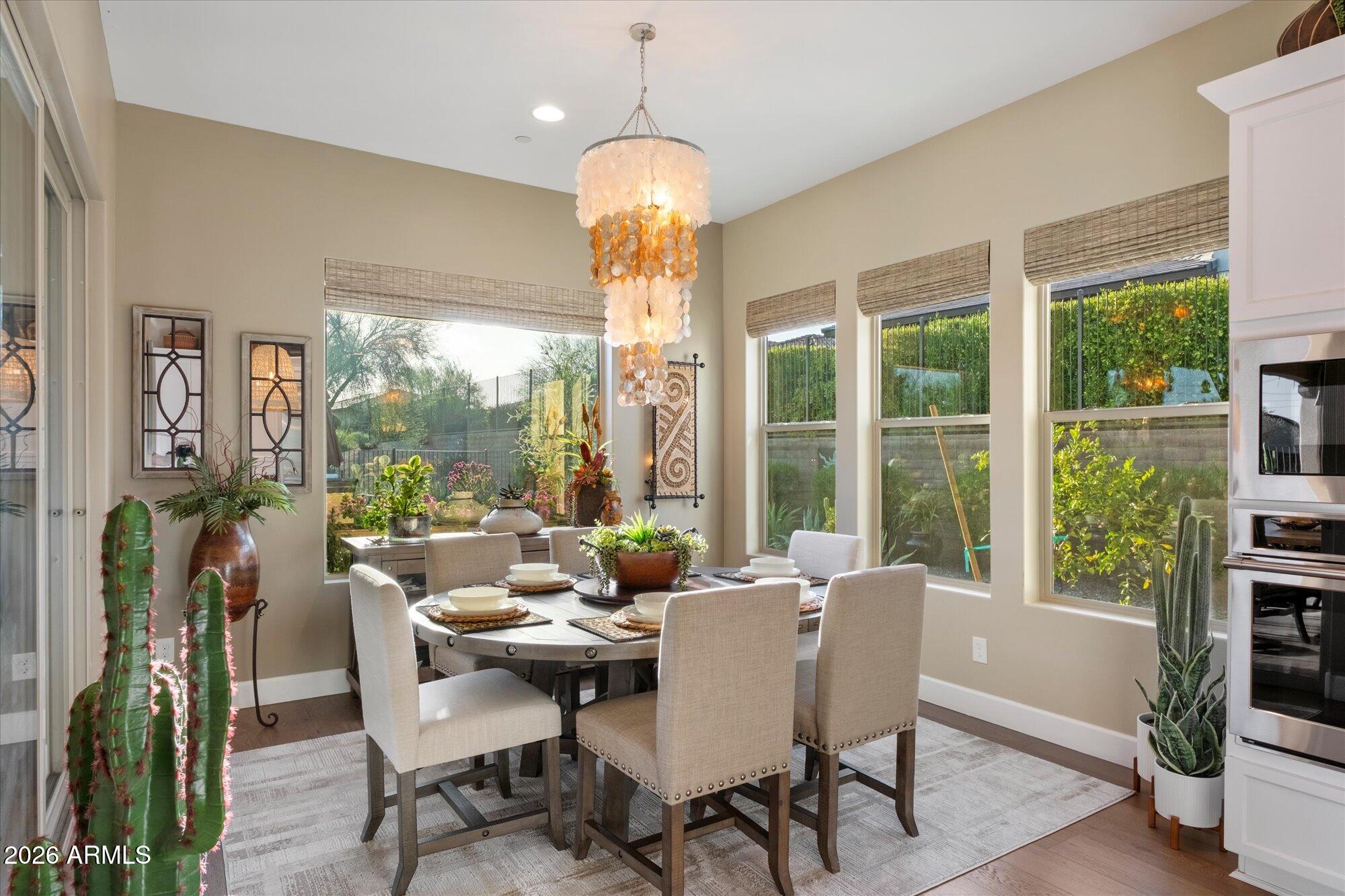 17561 Blaze Lane Rio Verde, AZ 85263 - Photo 12 of 46 a dining room with furniture large windows and a chandelier