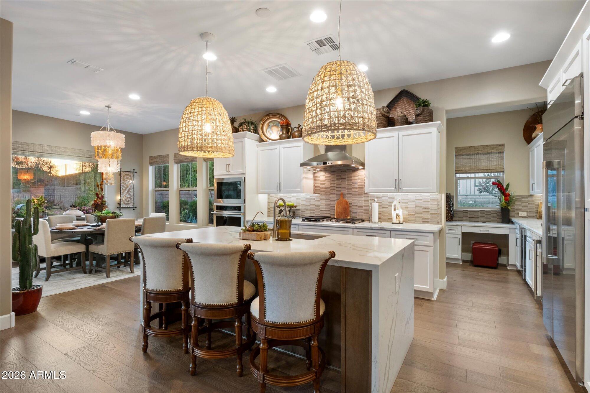 17561 Blaze Lane Rio Verde, AZ 85263 - Photo 14 of 46 a kitchen with a sink dining table and chairs