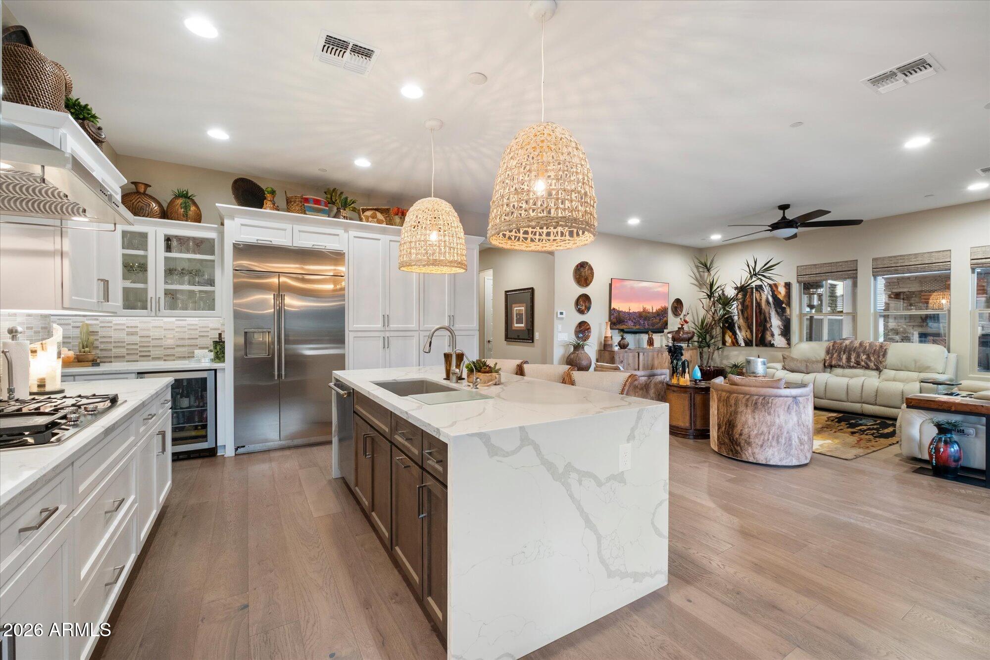 17561 Blaze Lane Rio Verde, AZ 85263 - Photo 15 of 46 a kitchen with counter top space stove and wooden floor