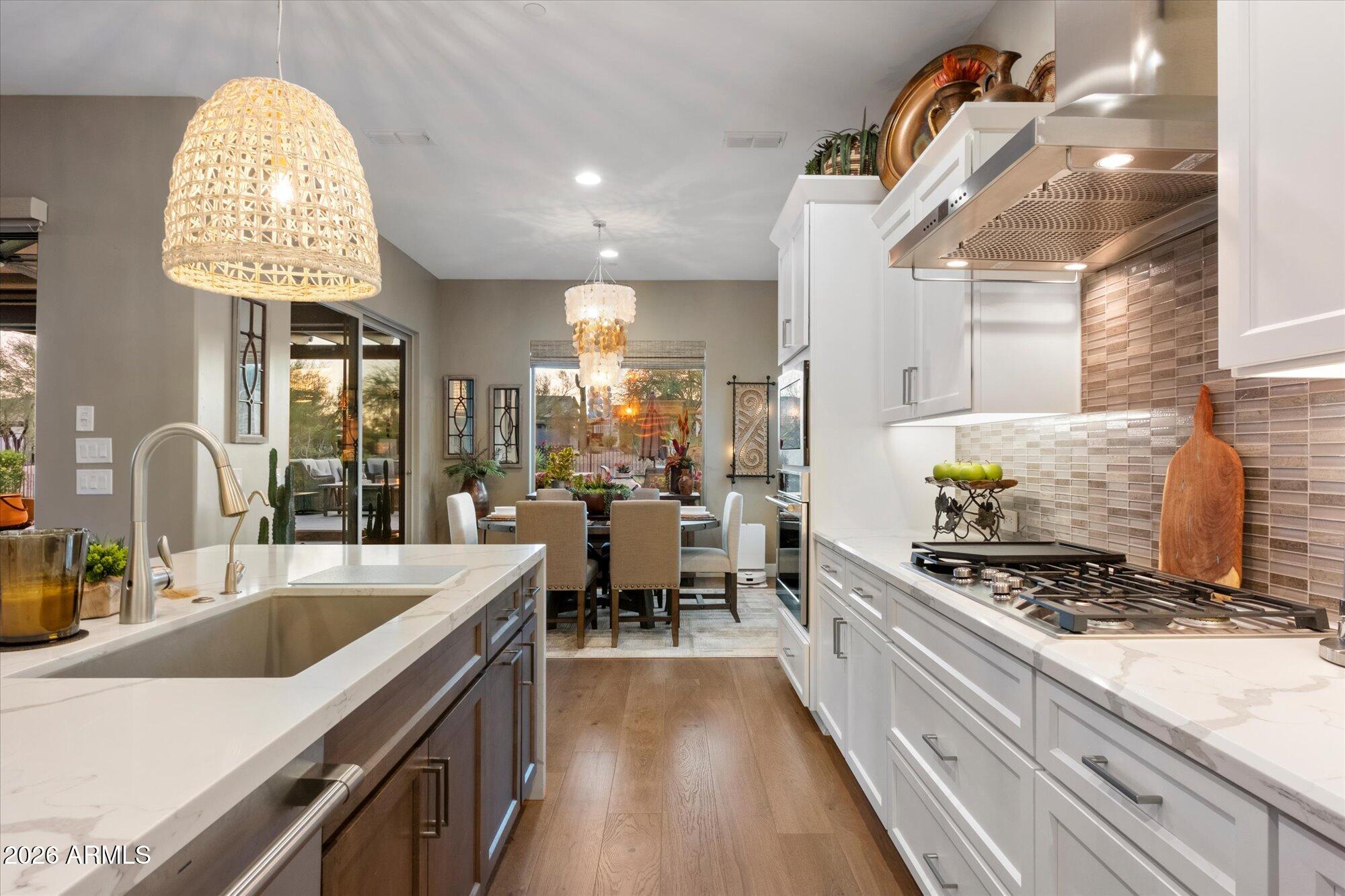 17561 Blaze Lane Rio Verde, AZ 85263 - Photo 16 of 46 a kitchen with stainless steel appliances granite countertop a sink stove and cabinets