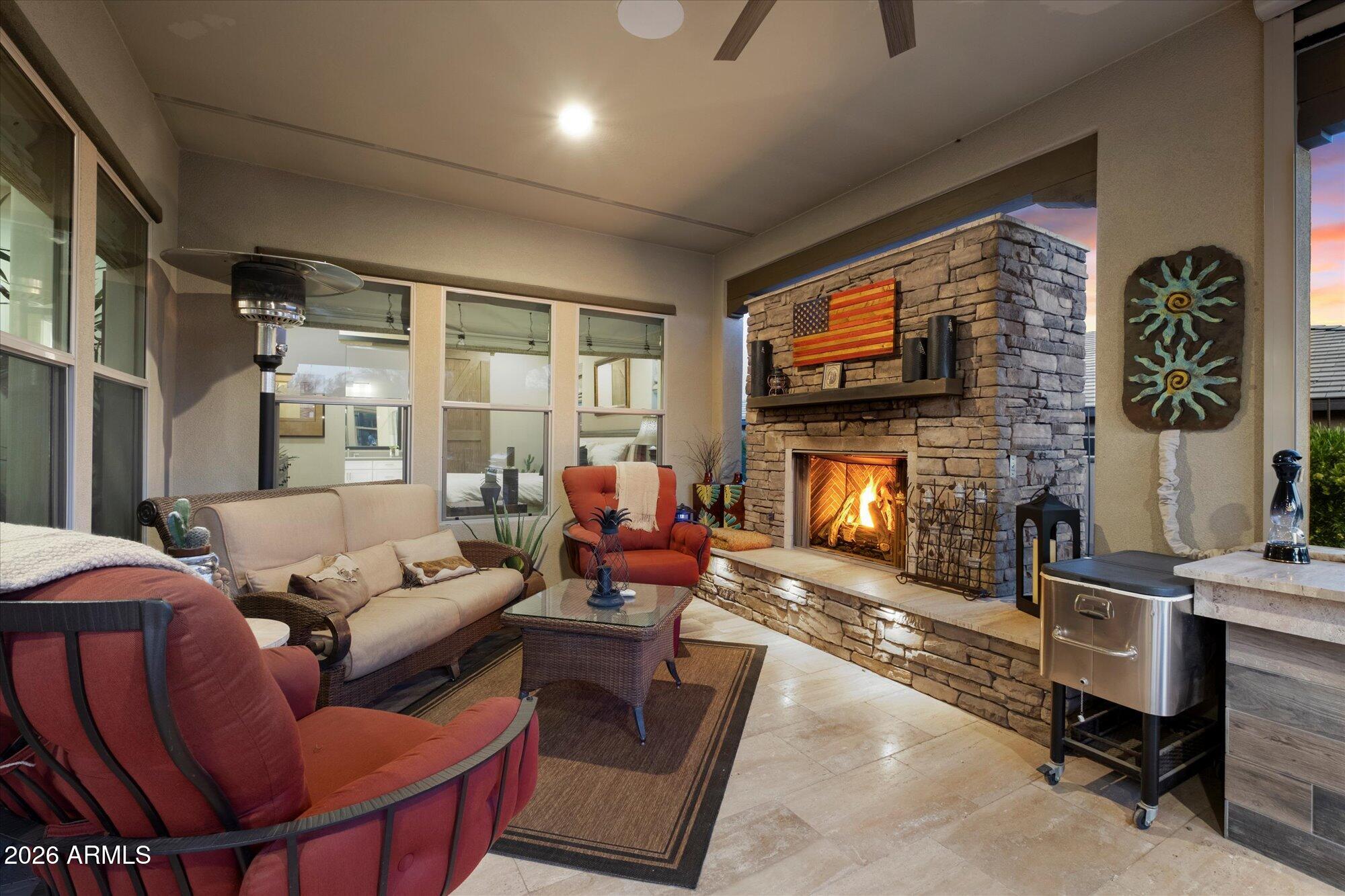 17561 Blaze Lane Rio Verde, AZ 85263 - Photo 31 of 46 a living room with furniture a fireplace and a flat screen tv