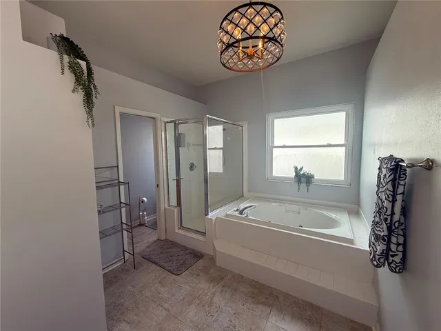 a bathroom with a bathtub and a shower