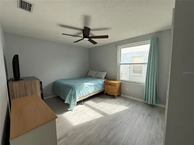 a bedroom with furniture and a window