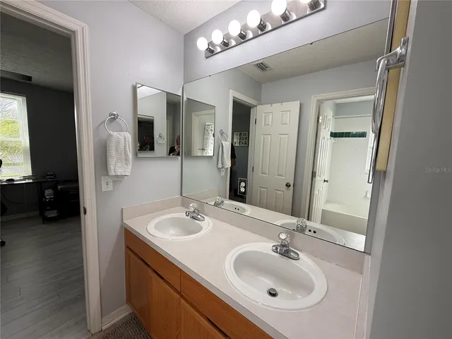 a bathroom with a sink double vanity and a mirror