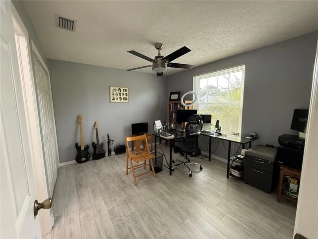 a view of a workspace with furniture and a window