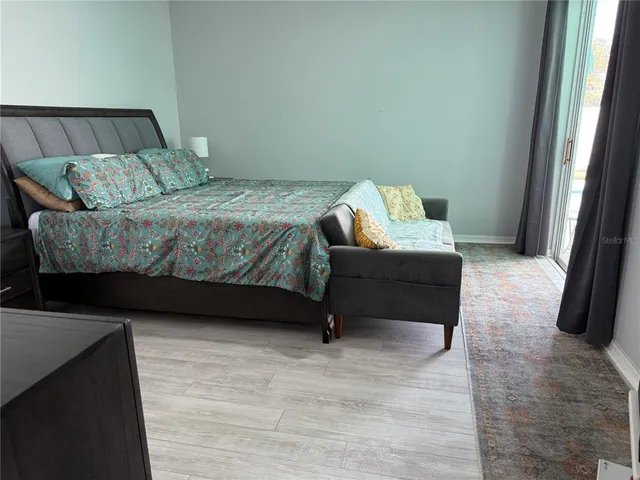 a bedroom with a bed and a couch