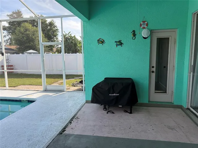 a living room with a large window and floor to ceiling window
