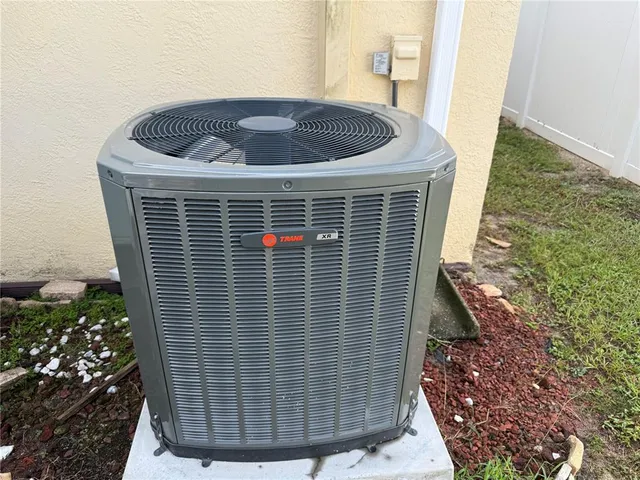 a view of an house with backyard space and balcony