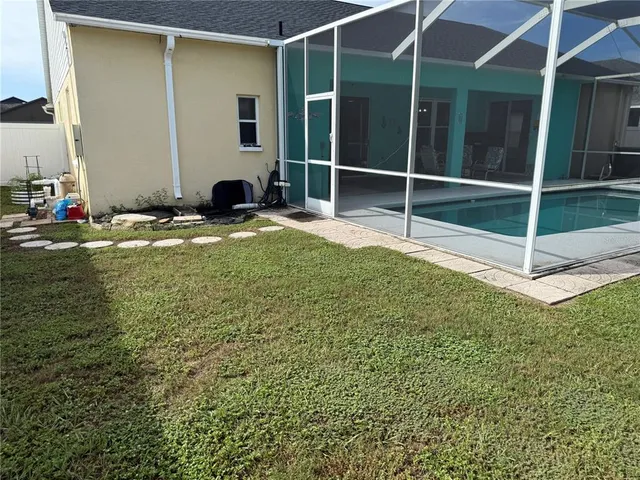 a view of a backyard with table and chairs