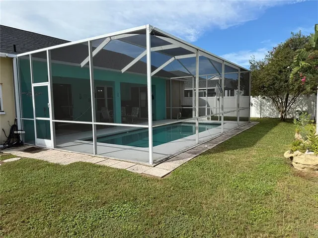 a view of a backyard with table and chairs
