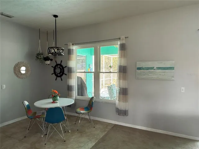 a dining room with furniture and window