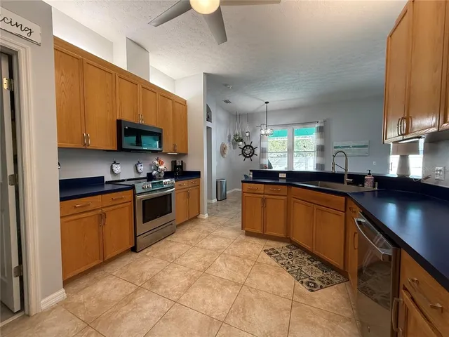 a kitchen with stainless steel appliances granite countertop a stove sink and cabinets