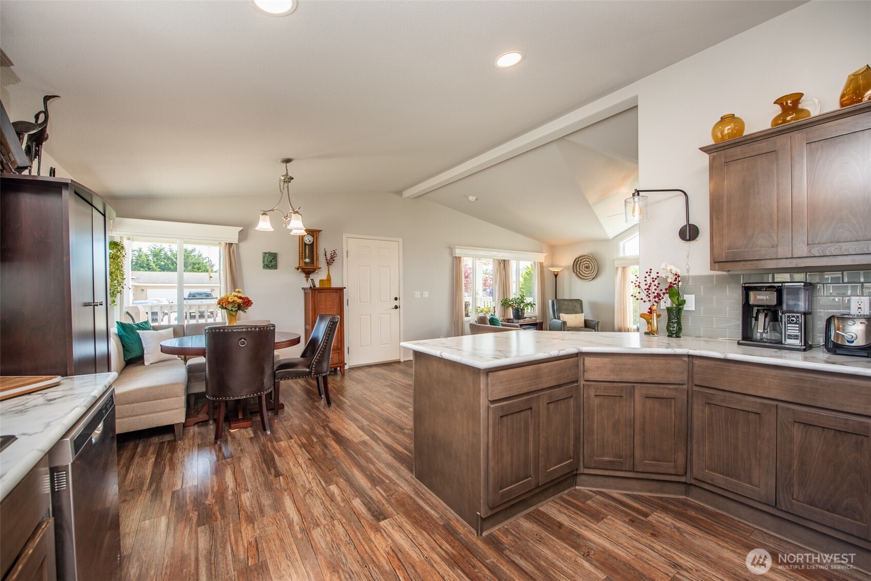 720 West Heritage Loop Sequim, WA 98382 - Photo 8 of 35 a kitchen with stainless steel appliances granite countertop a kitchen island hardwood floor sink stove dining table and chairs