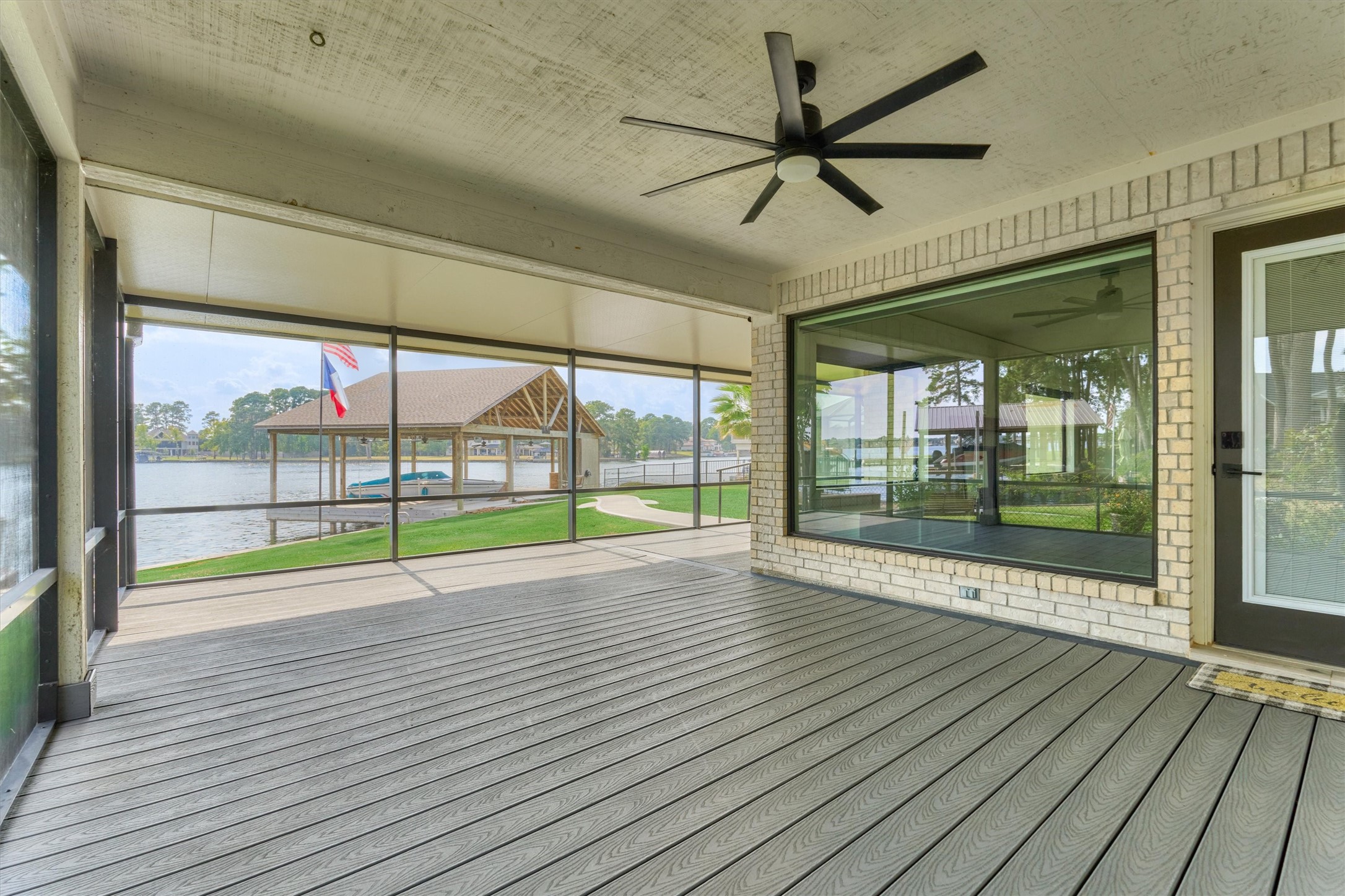 14696 South Diamondhead Conroe, TX 77356 - Photo 35 of 50 Spacious screened patio with incredible views of the lake. Notice the new tinted windows.