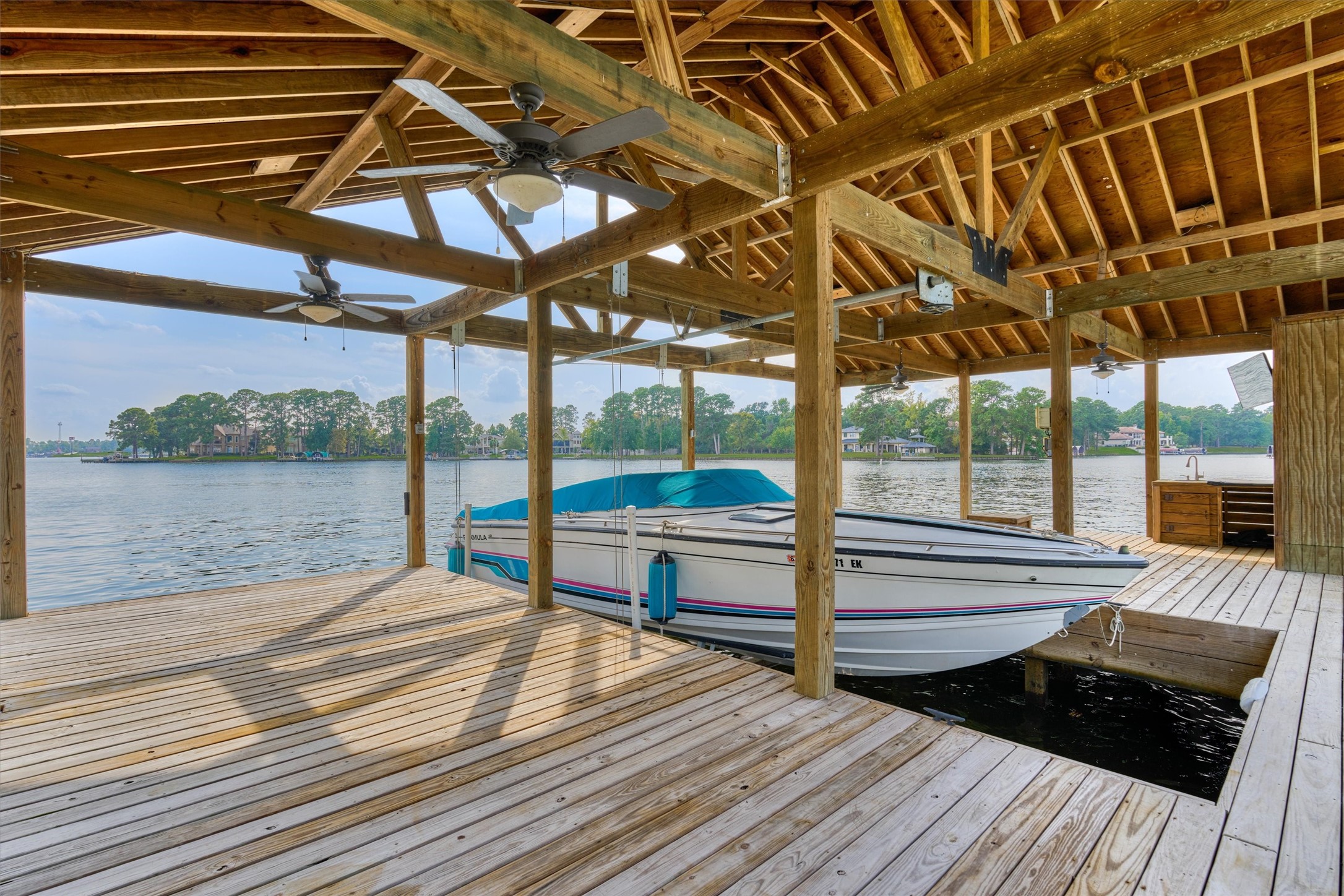 14696 South Diamondhead Conroe, TX 77356 - Photo 42 of 50 Large boathouse with fish cleaning station, ceiling fan and TV.