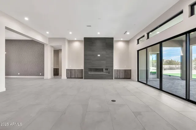 a kitchen with stainless steel appliances granite countertop a sink a stove and a wooden floors