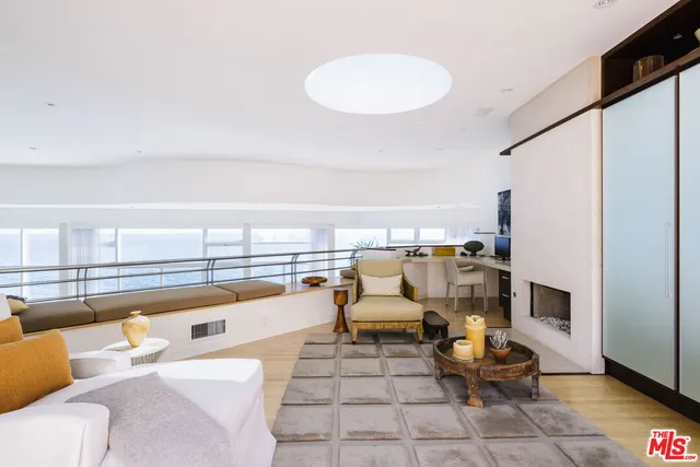 a living room with furniture and a floor to ceiling window