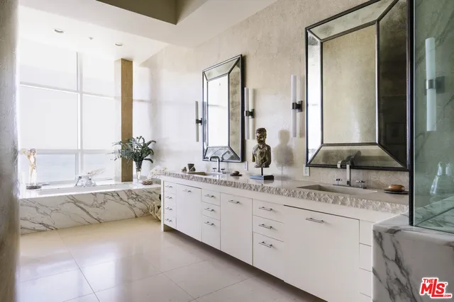 a large bathroom with double vanity and a mirror