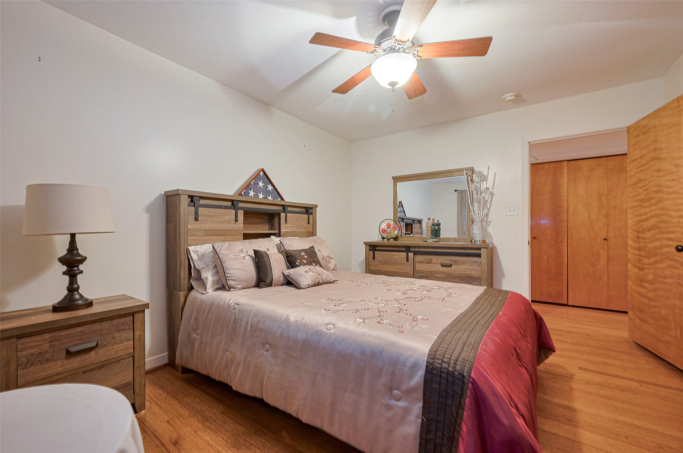 8019 Colgate Street Houston, TX 77061 - Photo 11 of 27 a bedroom with a large bed and a chandelier