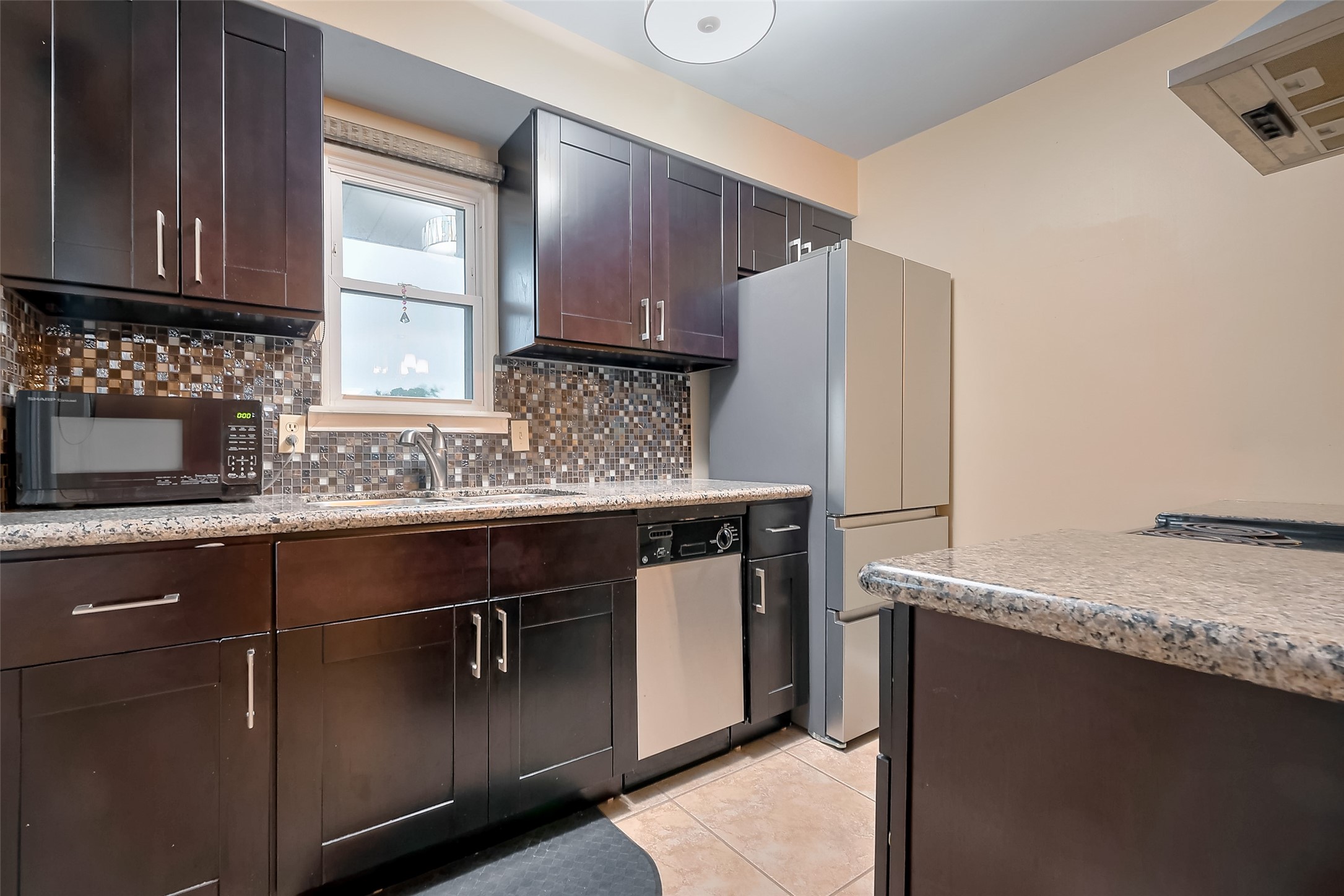 8019 Colgate Street Houston, TX 77061 - Photo 17 of 27 a kitchen with stainless steel appliances granite countertop a sink stove and microwave