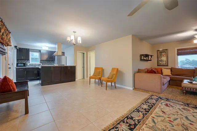 a living room with furniture and kitchen view