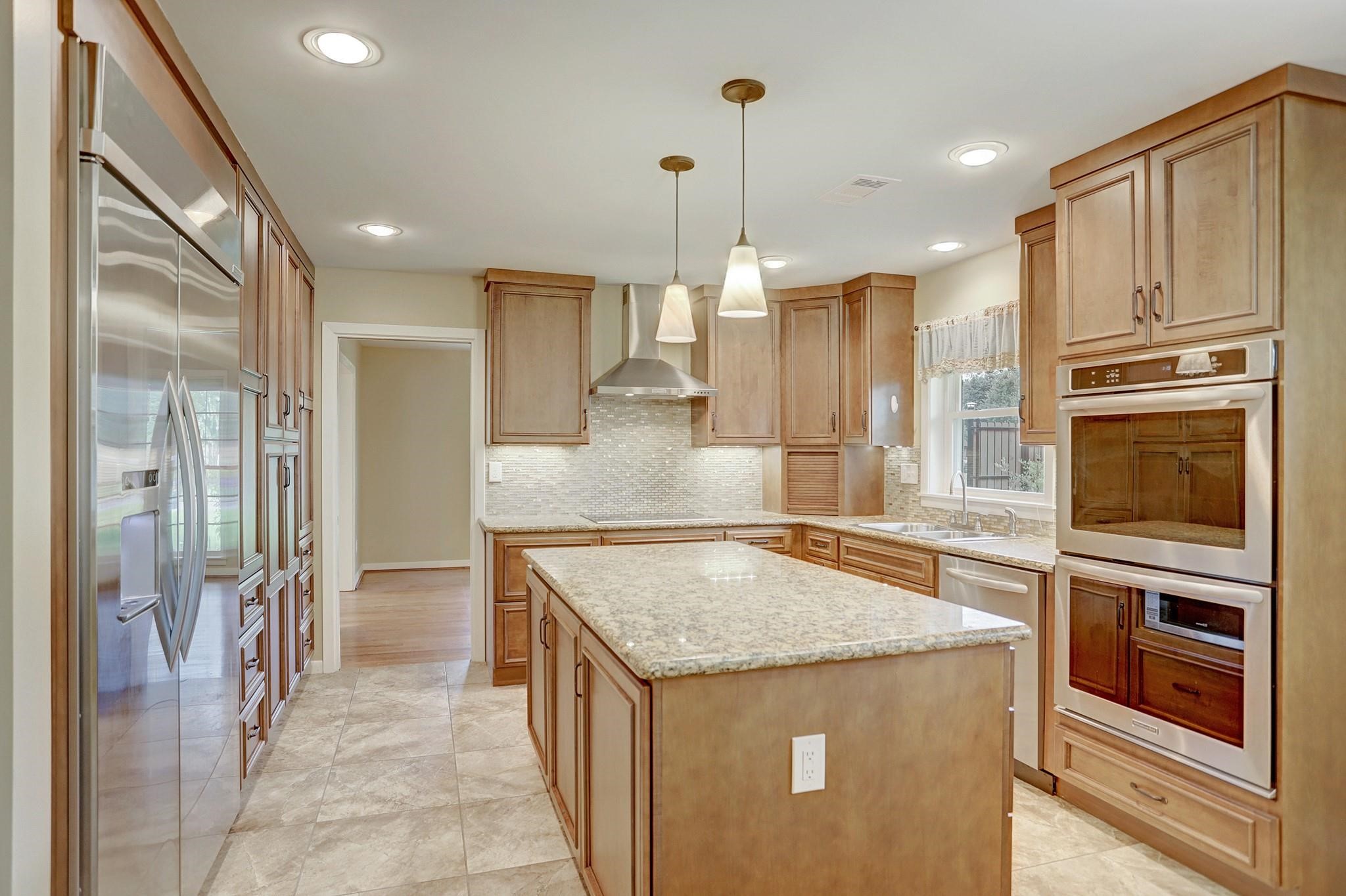 8019 Colgate Street Houston, TX 77061 - Photo 2 of 27 a kitchen with stainless steel appliances granite countertop a refrigerator and a stove top oven