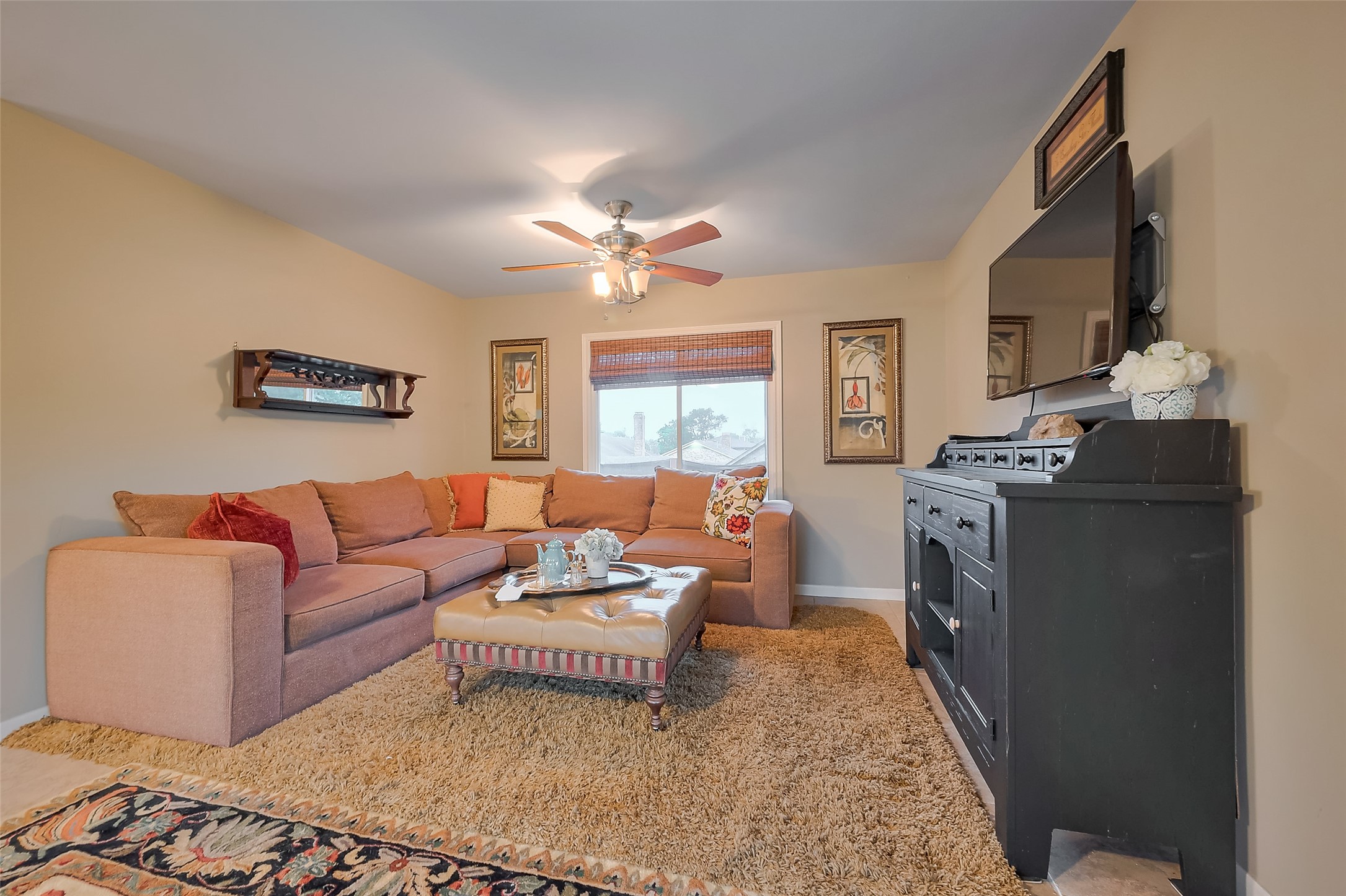 8019 Colgate Street Houston, TX 77061 - Photo 21 of 27 a living room with furniture a flat screen tv and a window