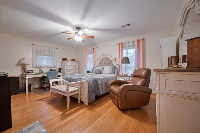 a bed room with furniture and wooden floor