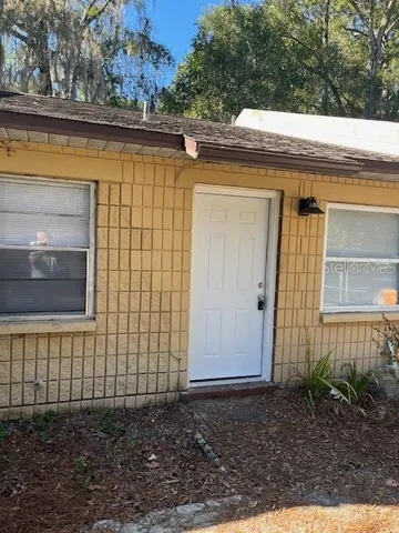 a view of a house with a backyard