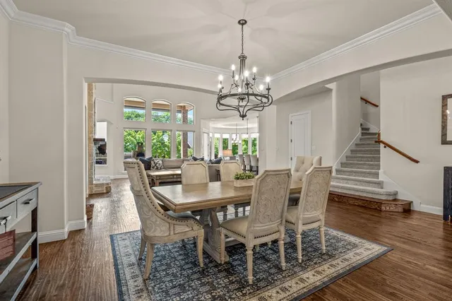 a view of a dining room with furniture wooden floor and chandelier