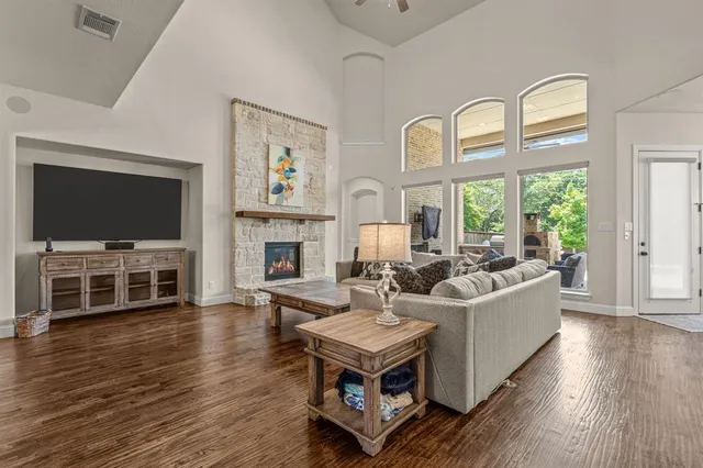 a living room with furniture a flat screen tv and a fireplace
