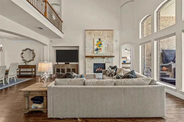 a living room with furniture a fireplace and a flat screen tv