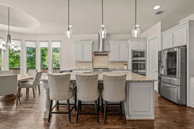 a view of a dining room with furniture large windows and wooden floor