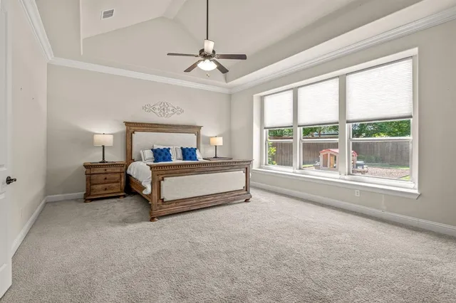 a bedroom with furniture and a large window