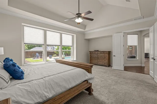 a spacious bedroom with a large bed and a large window