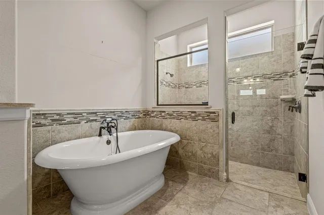 a bathroom with a bathtub and shower