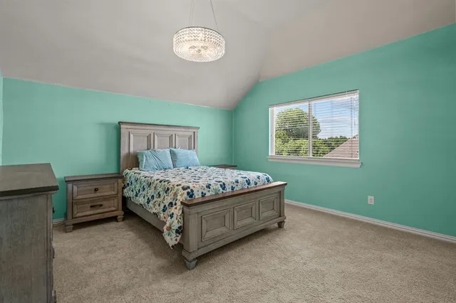 a bed sitting in a bedroom next to a window