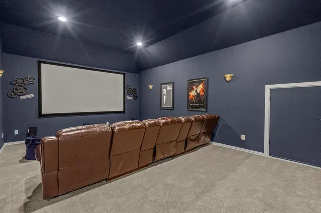 a living room with furniture and a projector screen