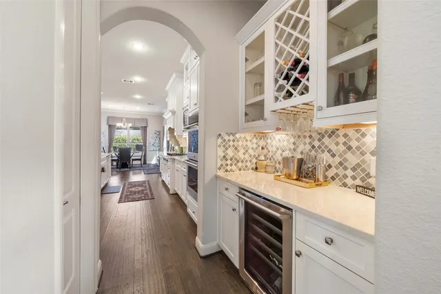 a view of a dining room with furniture and chandelier