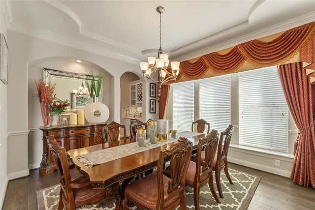 a living room with furniture and a book shelf