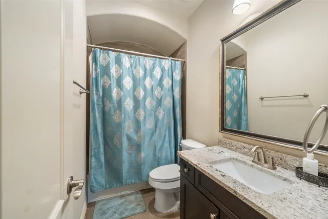 a spacious bedroom with a bed and window