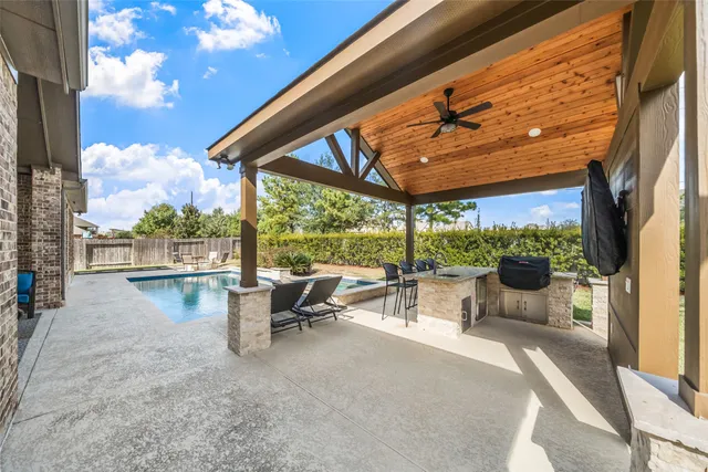 a view of swimming pool with outdoor seating