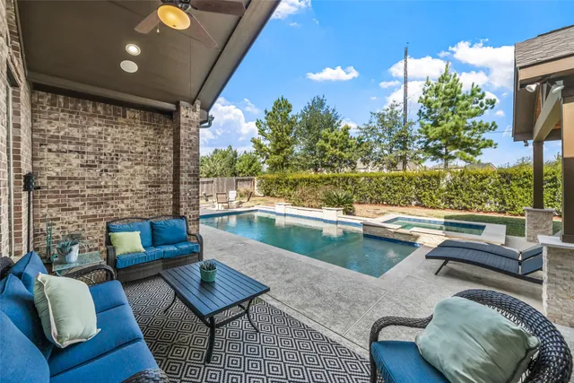 a view of swimming pool with outdoor seating and a yard