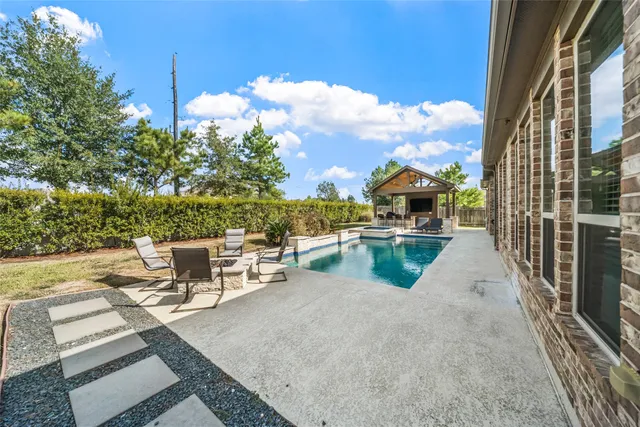 a view of a house with backyard sitting area and garden