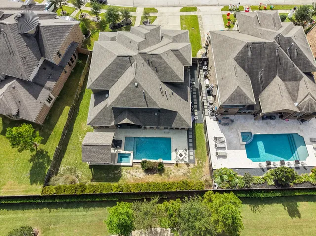 an aerial view of residential houses with outdoor space
