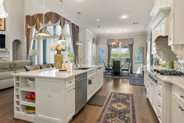 a dining room with furniture a chandelier and wooden floor