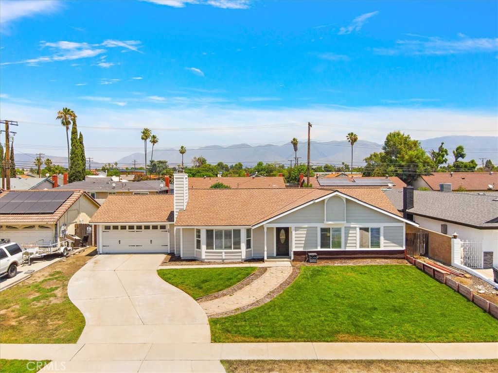 a view of a house with a big yard and large trees